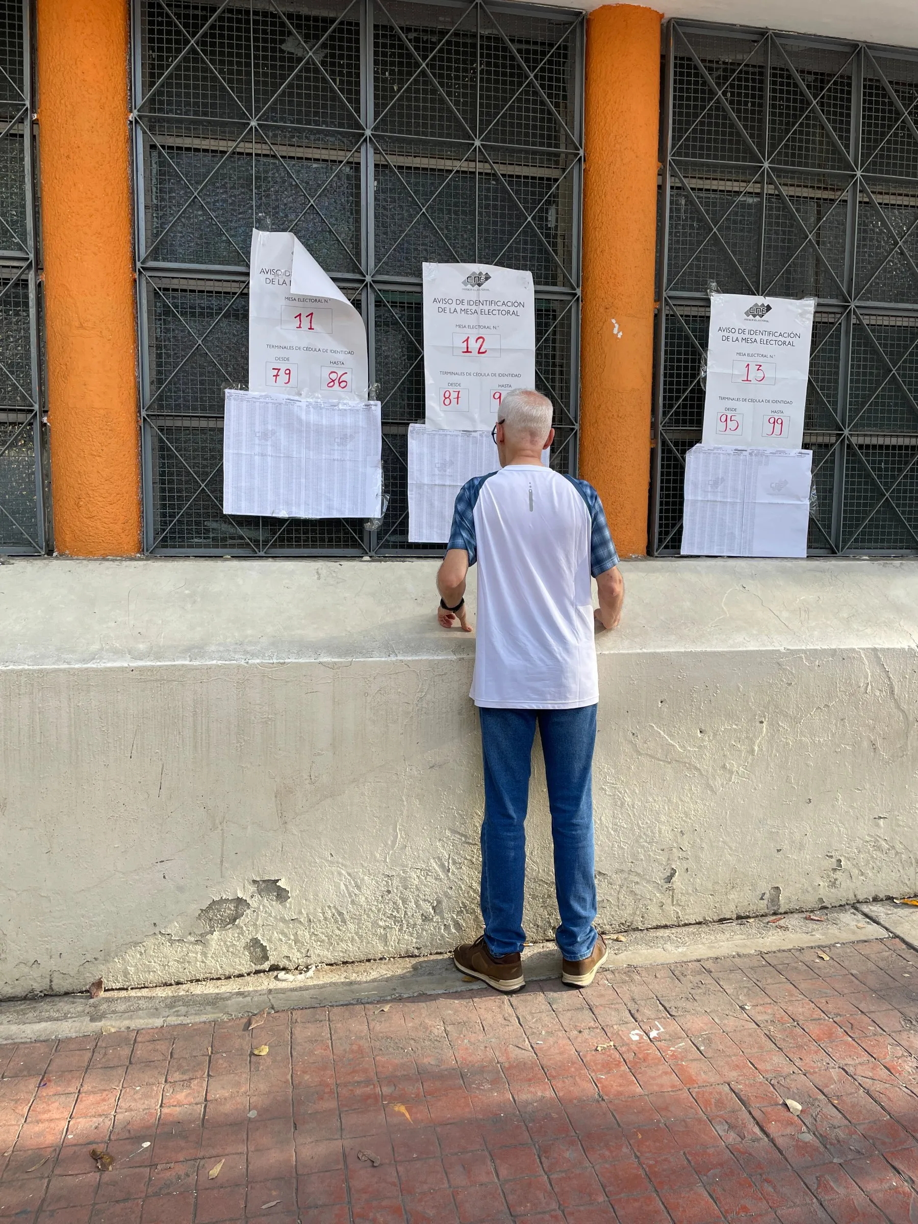 A voter checks a polling place register for his name.