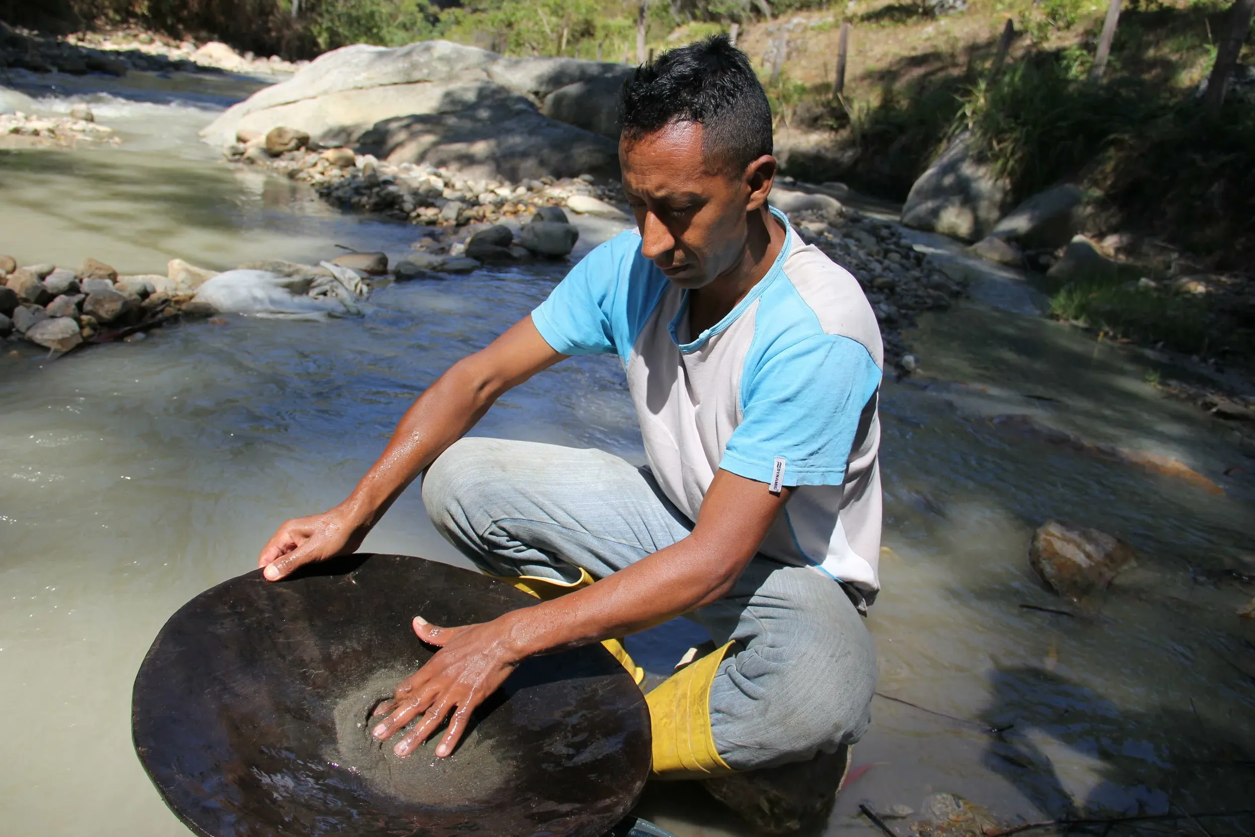 Martin Rangel pans for gold in the California river in Colombia.